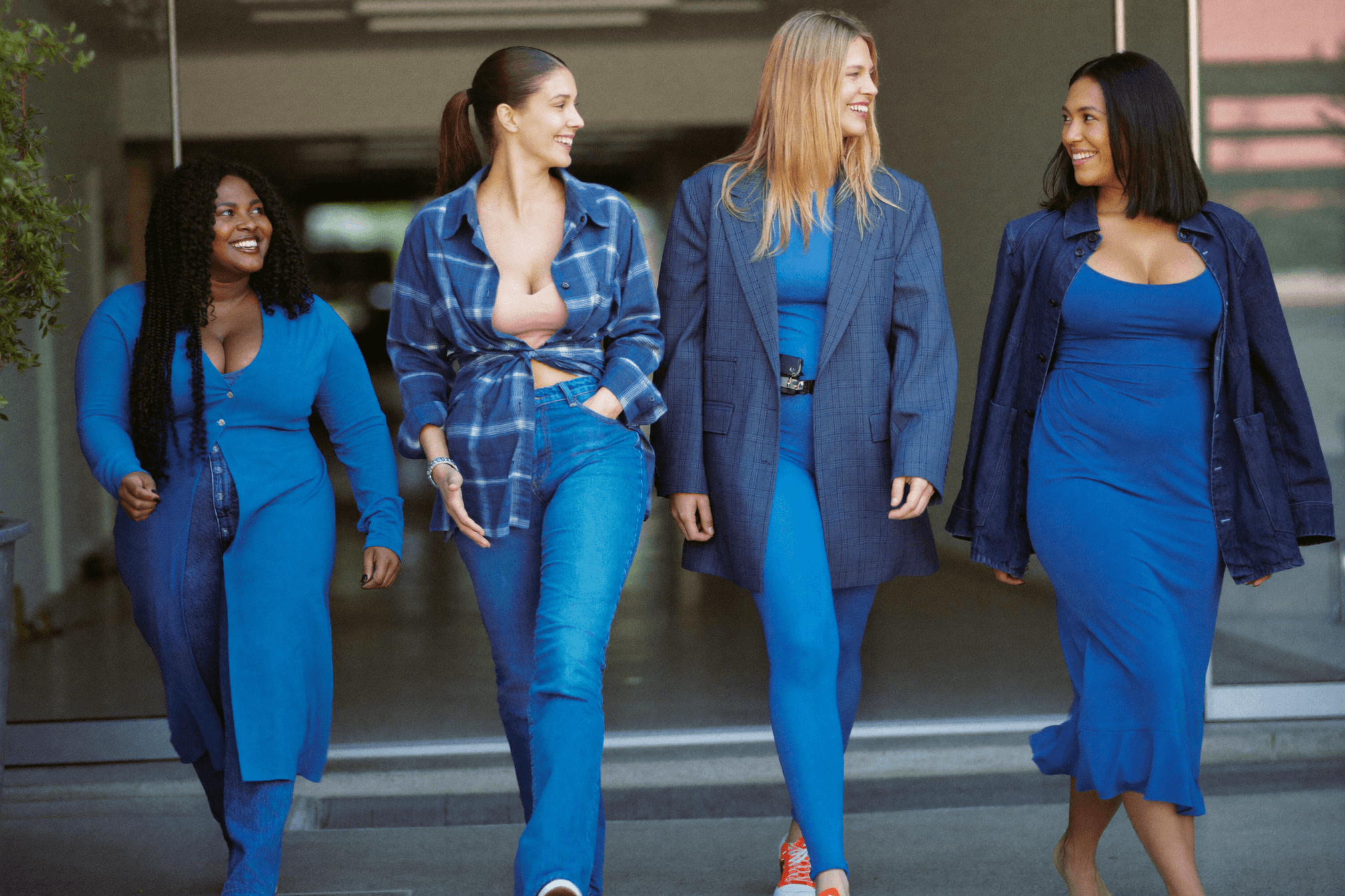 Confident women in different everyday outfits walking together, each dressed for concealed carry.